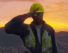 a man wearing a hard hat and safety vest salutes at sunset