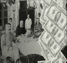 a black and white photo of a group of people sitting at a table with a pile of money behind them .