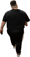 a man in a black t-shirt and black pants is walking