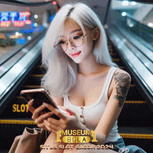 a woman sitting on an escalator looking at her phone with an ad for museum bola behind her