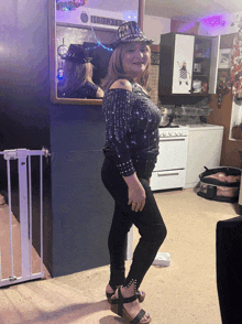 a woman wearing a hat that says happy new year is standing in front of a mirror