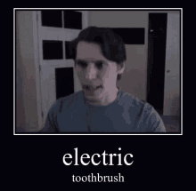 a man in a blue shirt is holding an electric toothbrush .