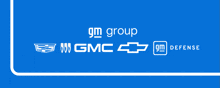 a blue background with gm group gmc chevrolet and gm defense written on it