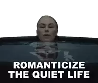 a woman is swimming in a tub with the words romanticize the quiet life above her