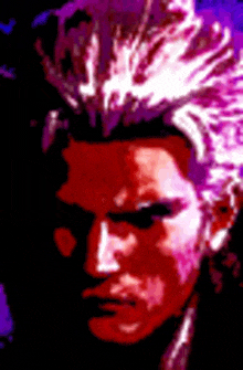 a close up of a man 's face with purple hair in a dark room .