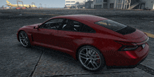 a red sports car is parked on a runway with a yellow plane in the background