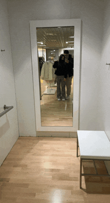 a couple taking a picture in a dressing room