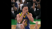 golden state warriors basketball player stephen curry giving a high five to the crowd