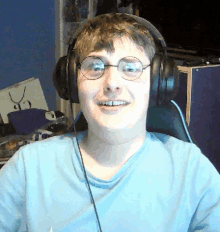 a man wearing headphones and glasses is smiling for the camera