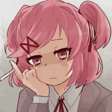 a pink haired anime girl is smoking a cigarette and making a sad face .