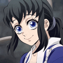 a girl with black hair and blue eyes is smiling and wearing a blue shirt