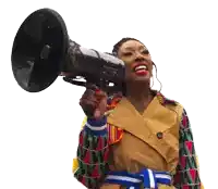 a woman in a trench coat is holding a megaphone in her hand