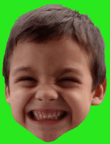 a close up of a young boy 's face with a green background