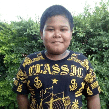 a young boy wearing a black and gold shirt that says classic