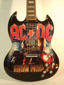 a guitar with ac dc iron man 2 on it