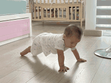 a baby is crawling on the floor in a room