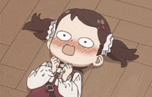 a girl with pigtails is laying on the floor with her mouth open