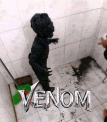 a person covered in venom standing in a bathroom next to a green broom