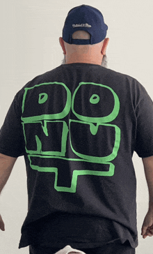 a man wearing a black t-shirt that says do nu on it