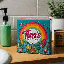 a box of tim 's tampons sits on a counter next to a soap dispenser