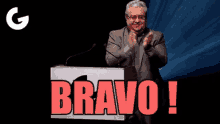 a man stands at a podium with the word bravo written on it