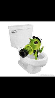 a toilet with a green plant with a gun on it