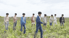 a group of young men are standing in a field and one of them is wearing a shirt that says ' i love you '