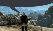 a man in a knight 's armor stands in front of a mountain range