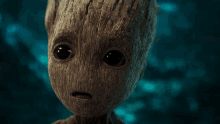 a baby groot from guardians of the galaxy looking at the camera