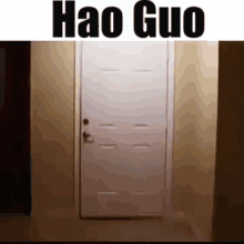 a white door is open in a hallway with the words hao guo written on it .