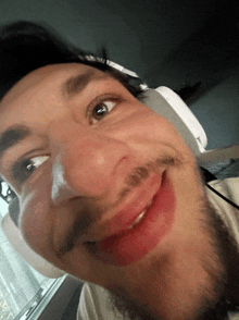 a close up of a man 's face with headphones