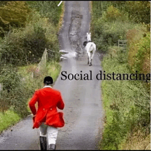 a man in a red coat is walking down a road with two horses behind him and the words social distancing written on the bottom