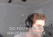 a man wearing headphones is sitting in a living room and says `` do you have my driver 's license '' .