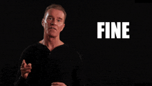 a man stands in front of a black background with the words fine and dandy on it