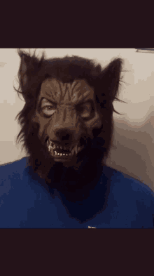 a person wearing a werewolf mask with fangs