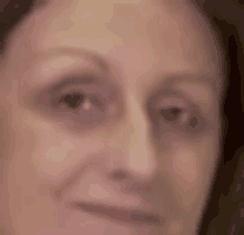 a close up of a woman 's face with a smile on her face .