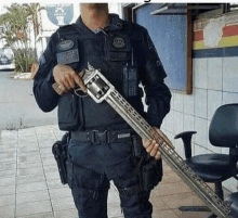 a man in a military uniform is holding a long gun .