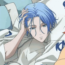 a person with blue hair is laying in bed