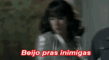 a woman says beijo pras inimigas in a foreign language .