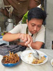 a man is eating a plate of food with a camera strap that says nikon on it