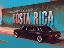 a car is parked in front of a sign for costa rica