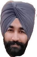 a man with a beard wears a turban and looks at the camera