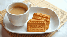 a cup of coffee and a plate of parle g cookies