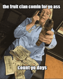 an older woman is holding a gun in front of a pile of money with the caption " the fruit clan comin for yo ass "