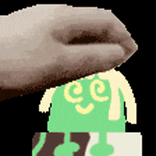 a pixel art of a hand putting something on top of a cartoon character