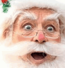 a close up of santa claus 's face with glasses and a surprised look on his face .