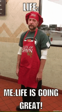 a man wearing an apron that says taste of spain and a chef hat