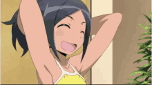 a girl in a yellow tank top is smiling with her hands behind her head