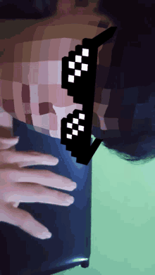 a pixelated image of a person wearing a pair of glasses