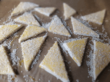 a bunch of triangles covered in sesame seeds and butter